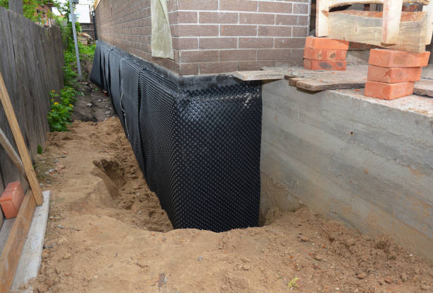 Happy homeowners after waterproofing job in Caroline